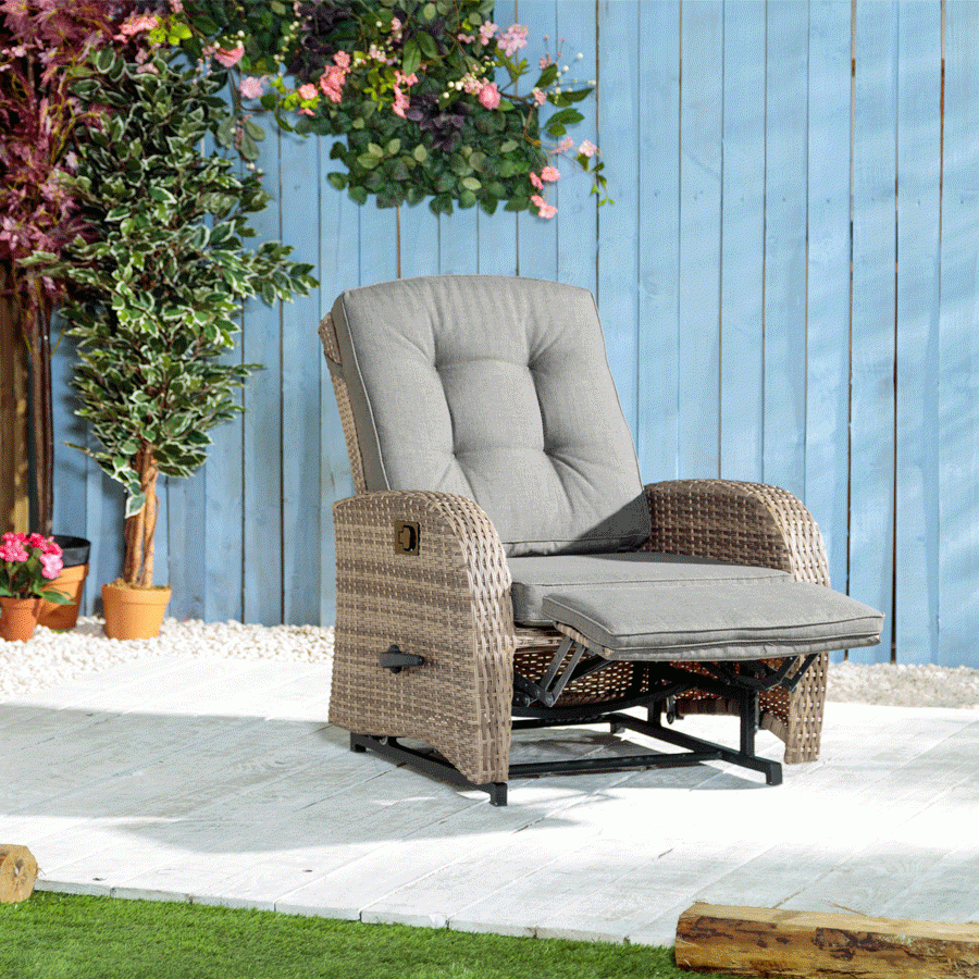 A Wicker Reclining Chair And Ottoman In Front Of A Blue Wall With Pink ... inside Bellevue Outdoor Ottoman