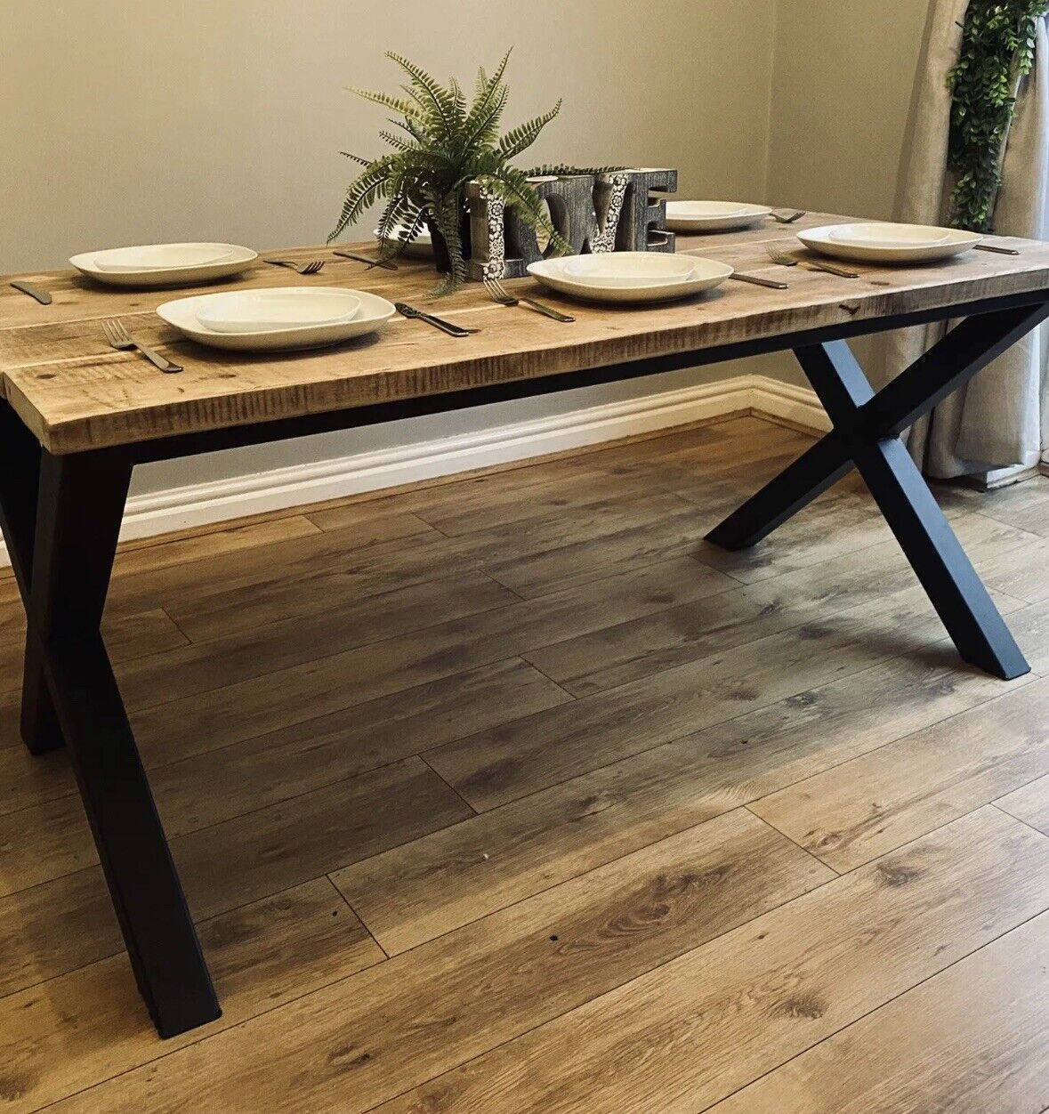 Understanding the Appeal of Rustic Dining Tables with Metal Cross Legs